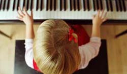 kid playing piano